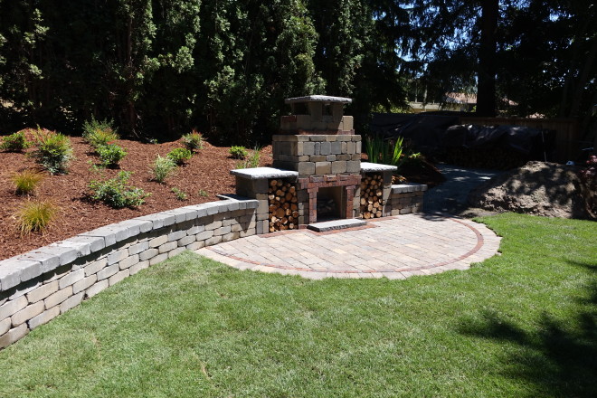 TuscanStone Fireplace with retaining wall and Dominion Slate Patio (project by Dreamscapes)