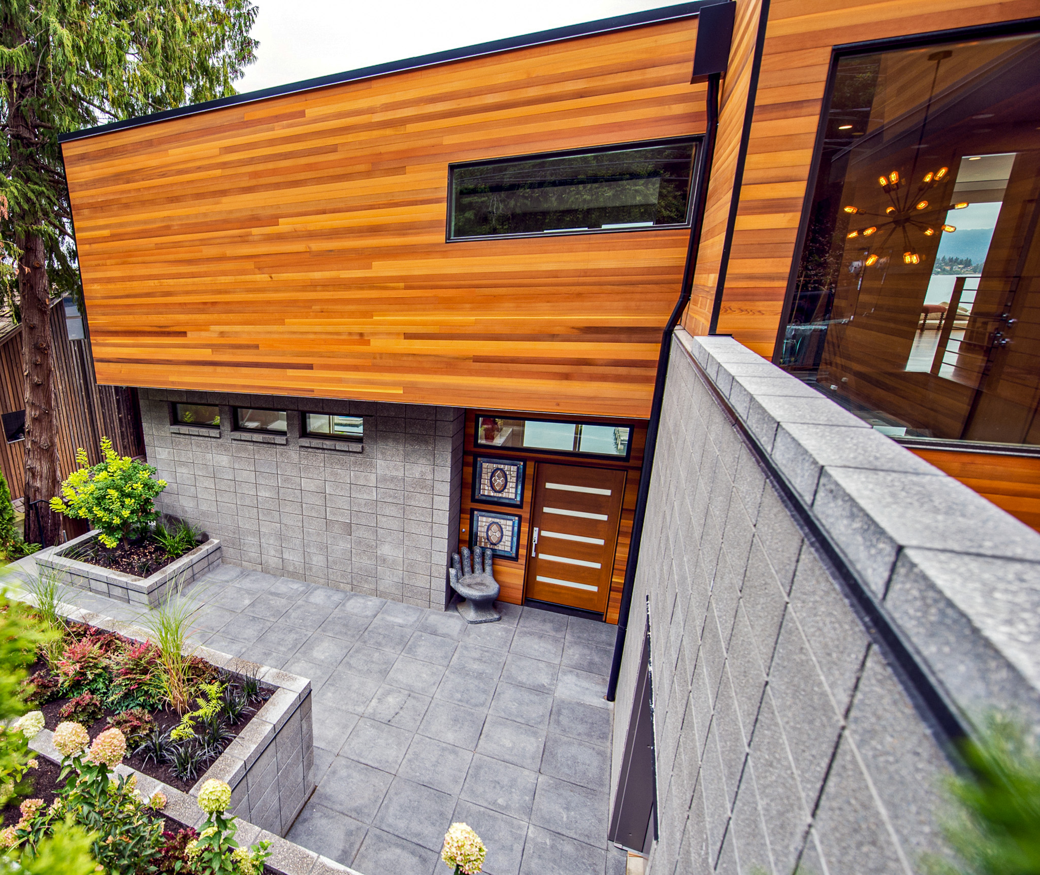Outdoor space consisting of Charcoal ground face CMU and Vancouver Bay architectural slabs