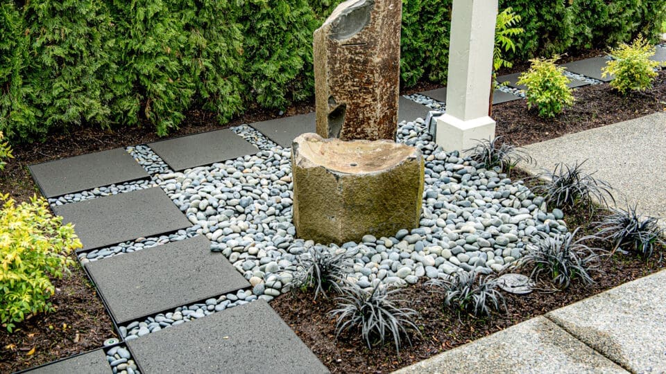 Small water feature surrounded by architectural slabs