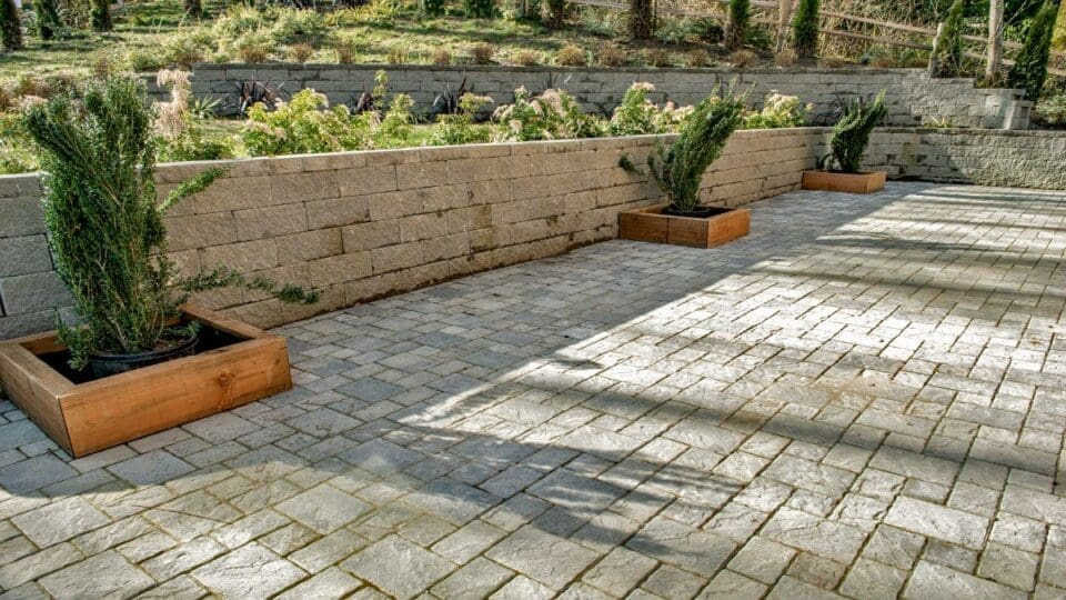 paver patio bordered by a terraced retaining wall