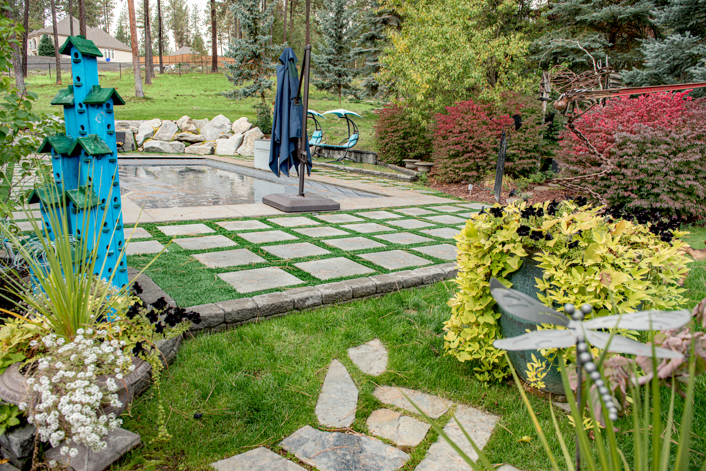 Outdoor living space with swimming pool and patio with architectural slabs