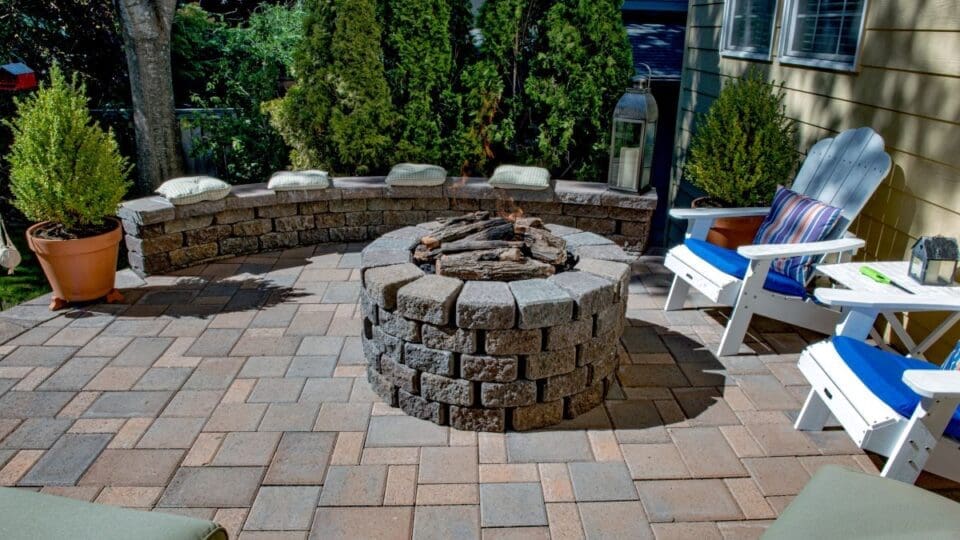 Outdoor living space with paver patio, seating wall, and fire pit