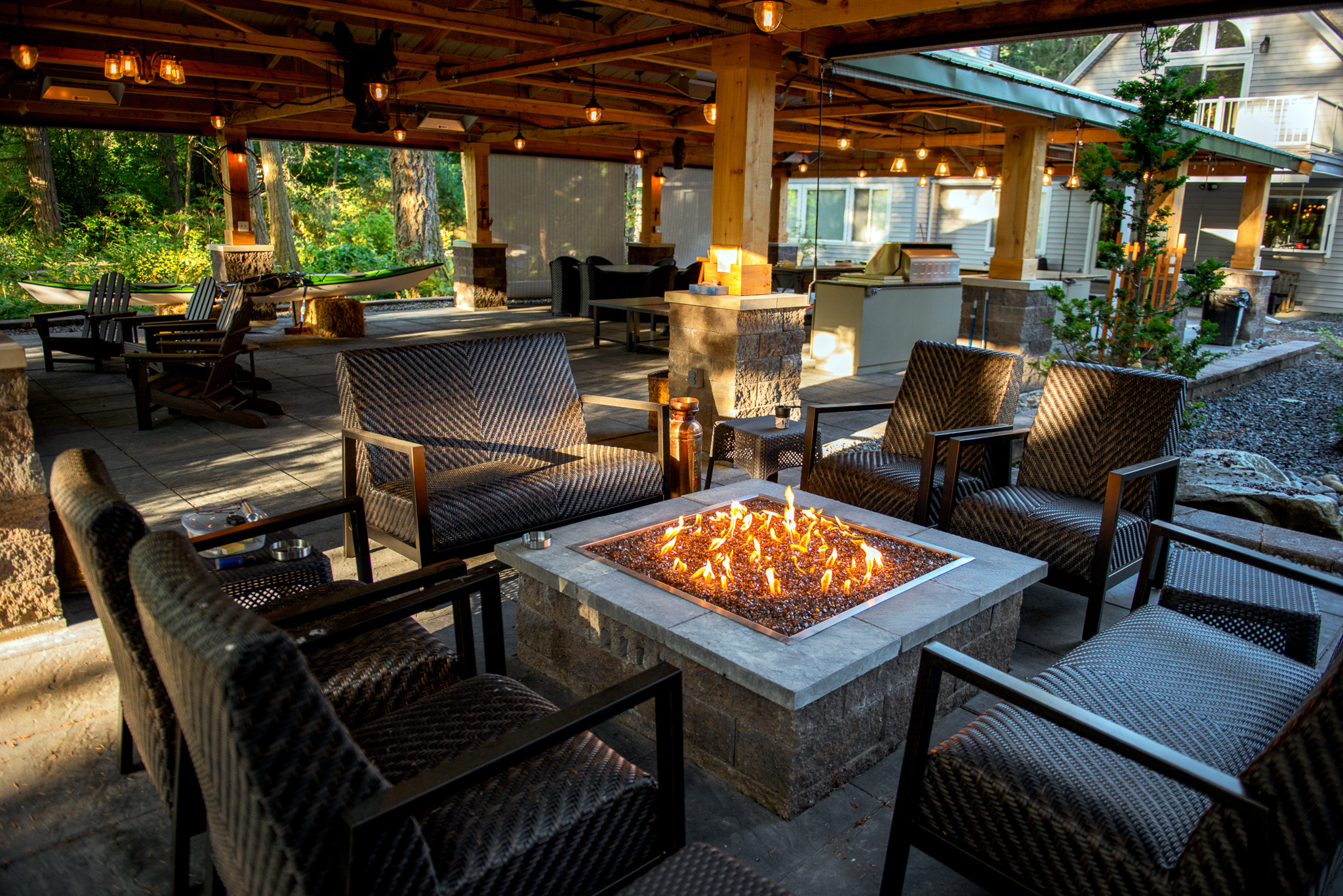 Outdoor fire pit with a kitchen in the background