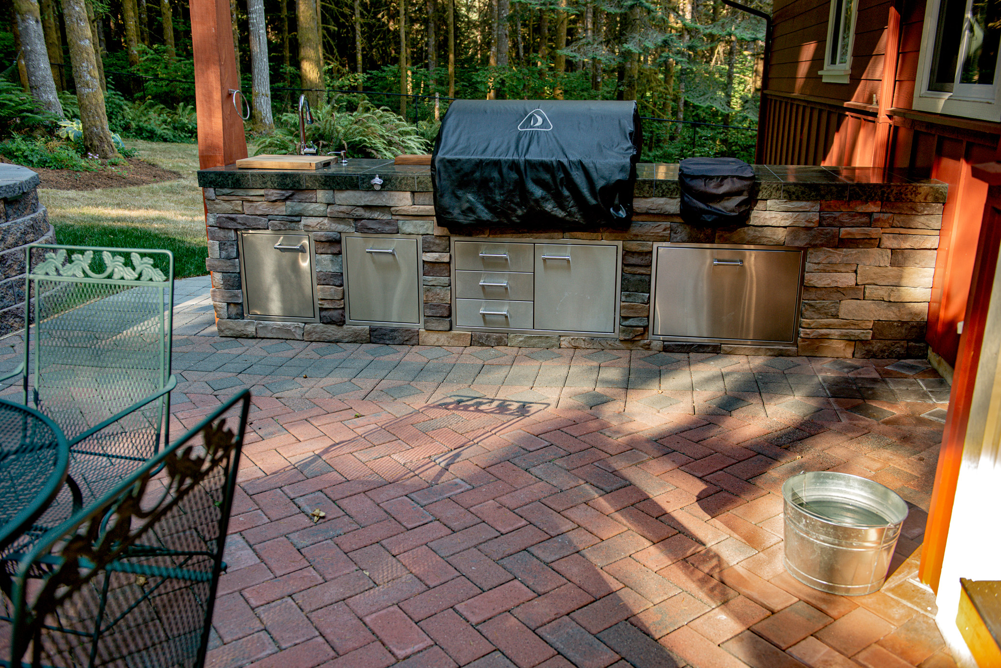 Outdoor kitchen faced with Cultured Stone on a paver patio