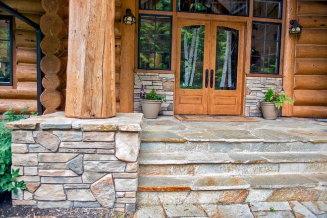 Aspen dressed fieldstone on a home's entrance with flagstone steps