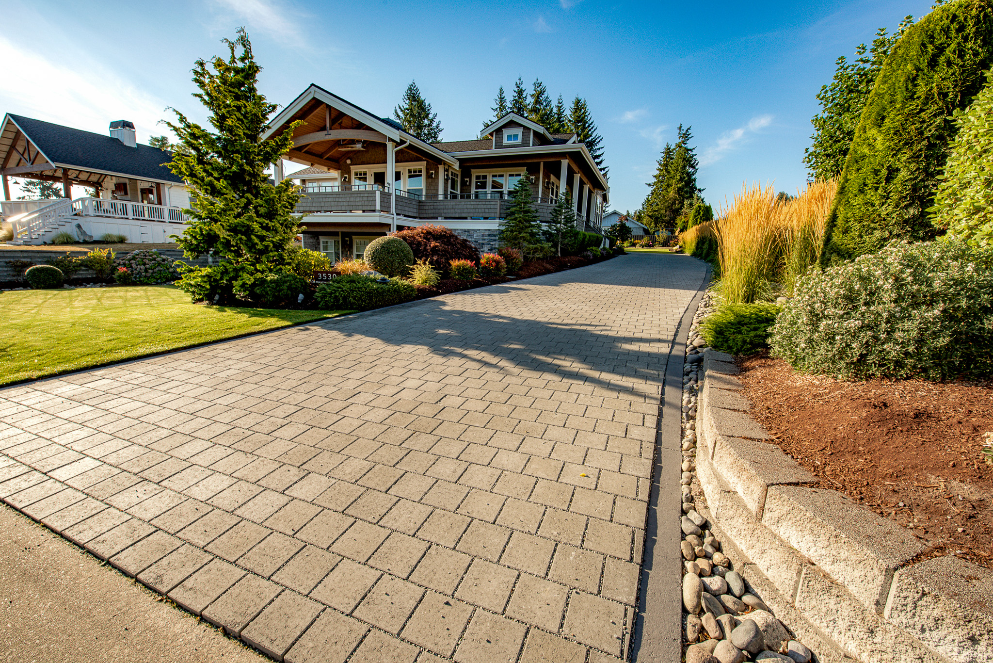 Permeable paver driveway runs alongside a home