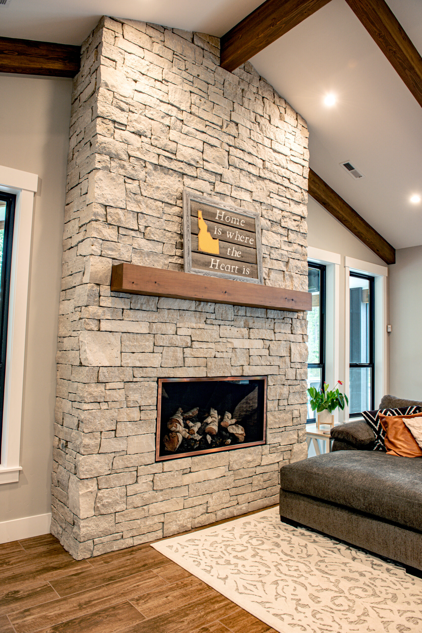Modern indoor fireplace faced with white natural stone veneer
