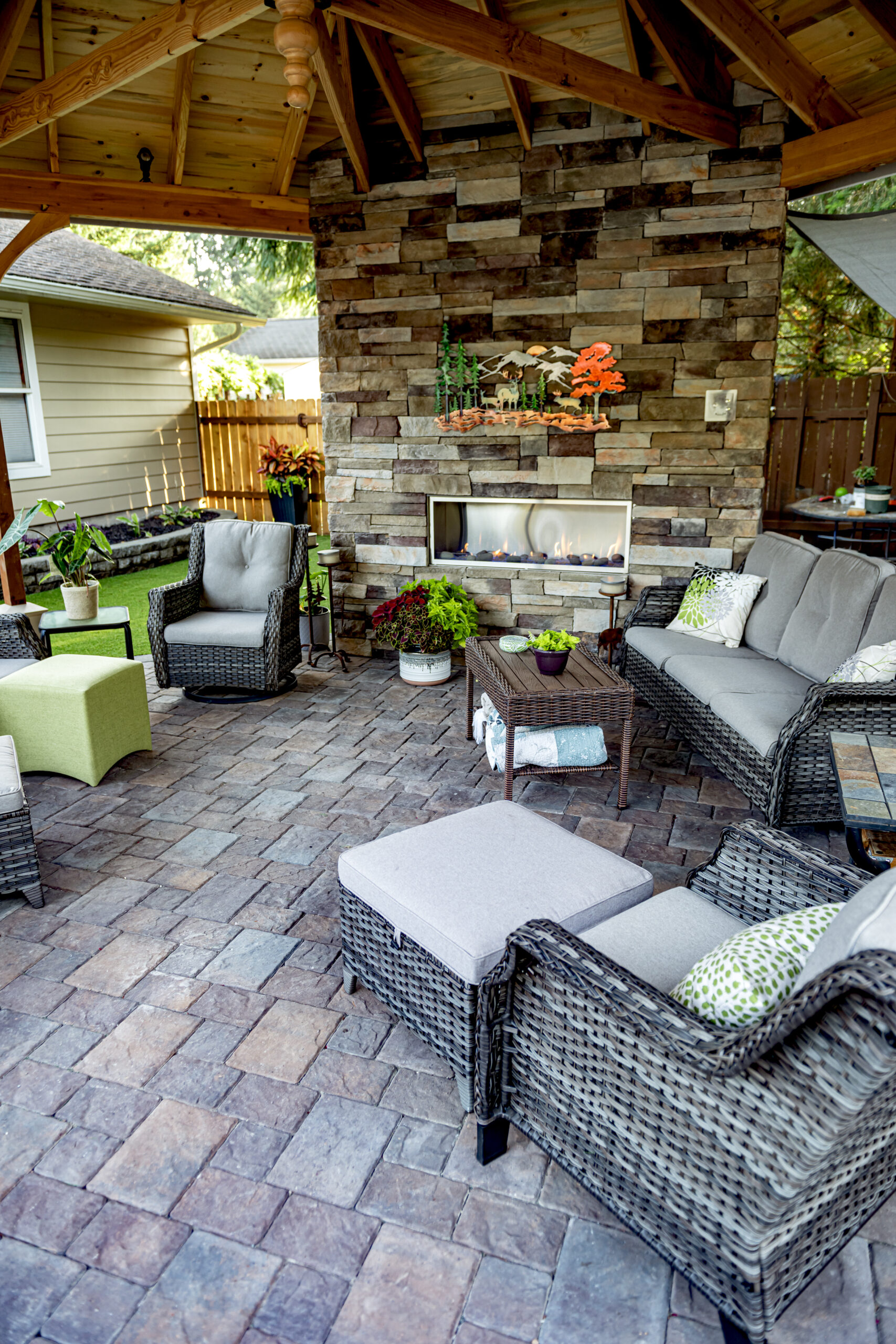 Outdoor living space with Cultured Stone fireplace and concrete paver patio