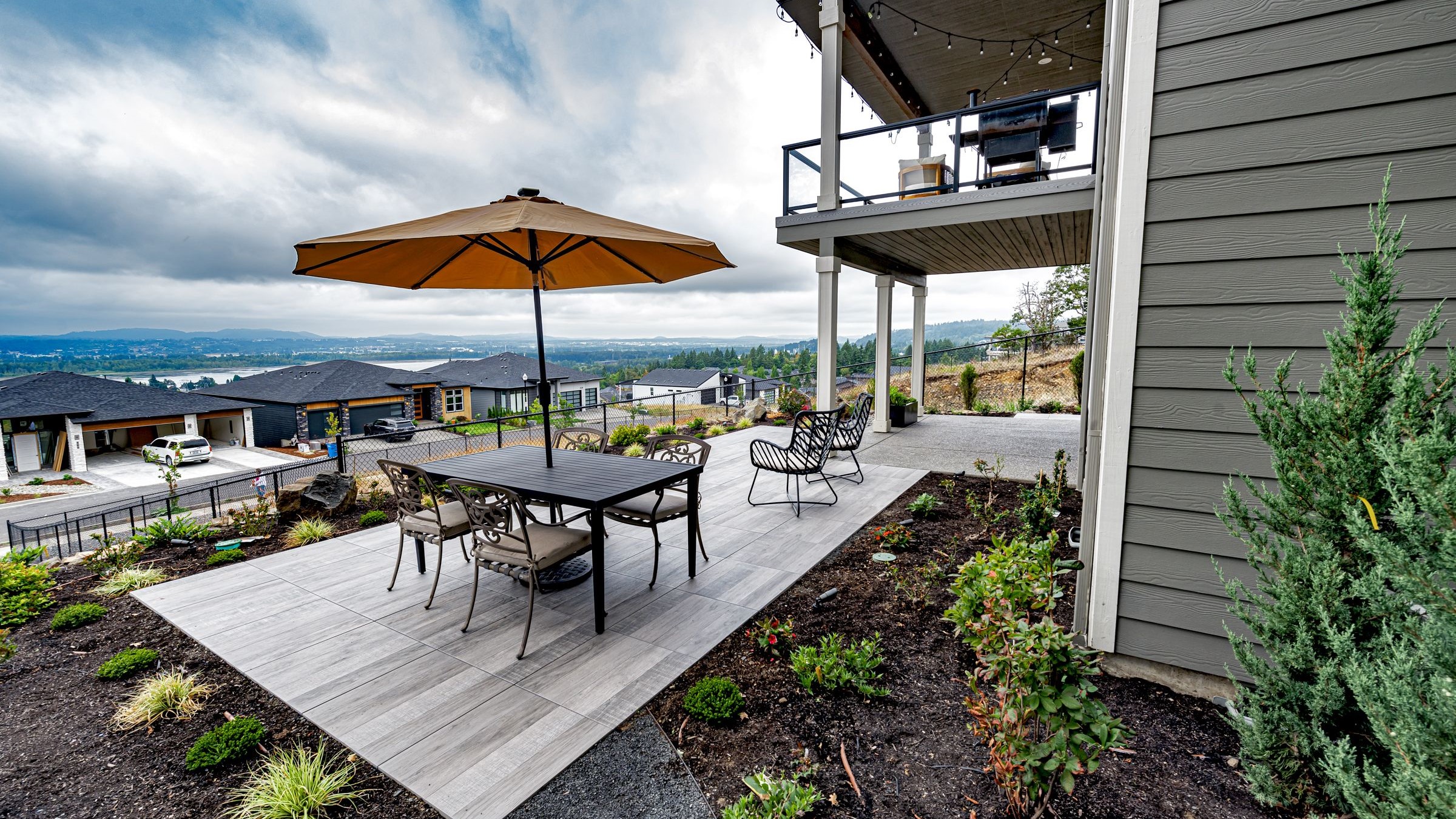 Porcelain paver patio perched above surrounding community