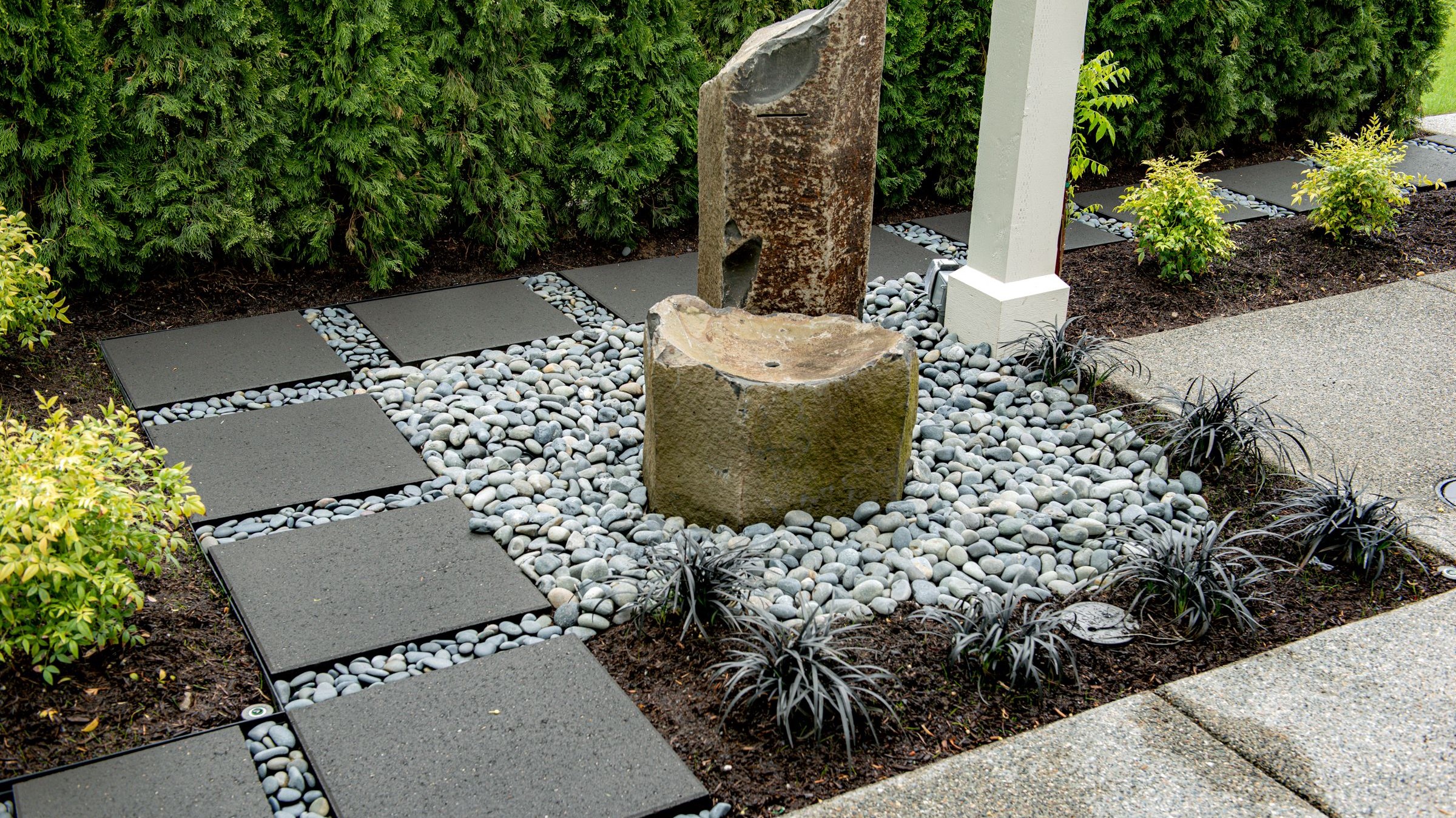 Basalt stone bubbler bordered by Vancouver Bay architectural slabs