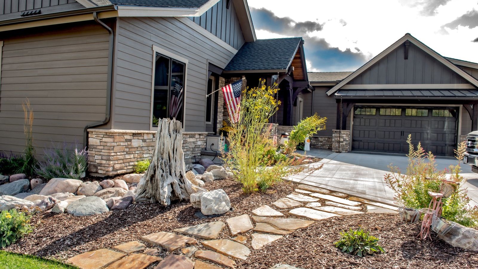 Bronze flagstone path connects yard to a driveway