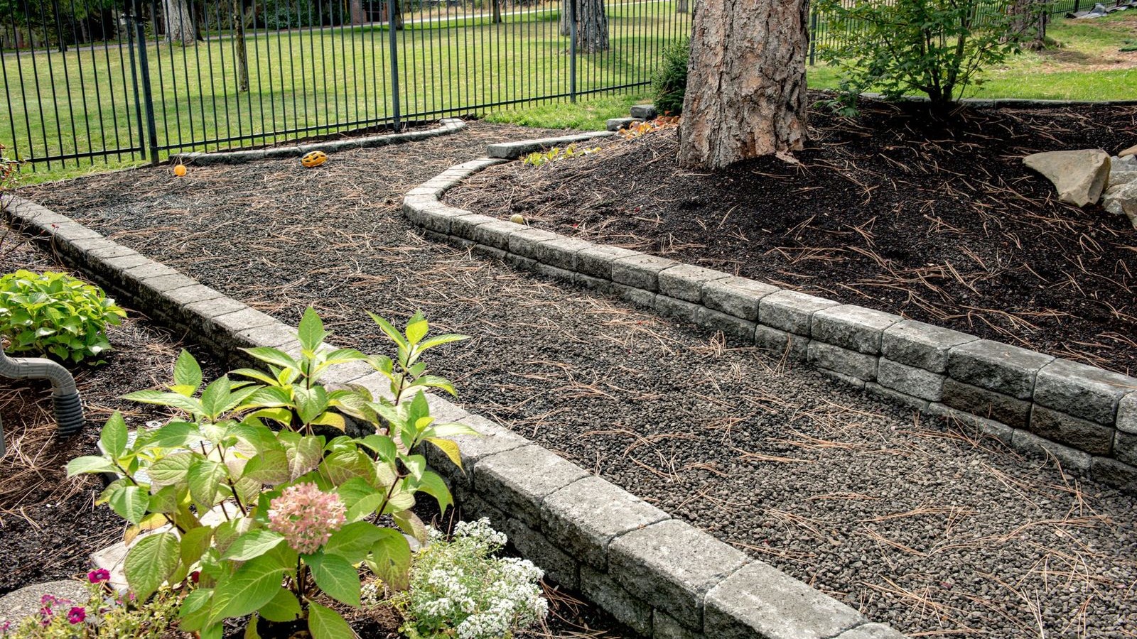 Gravel pathway lined with small retaining walls